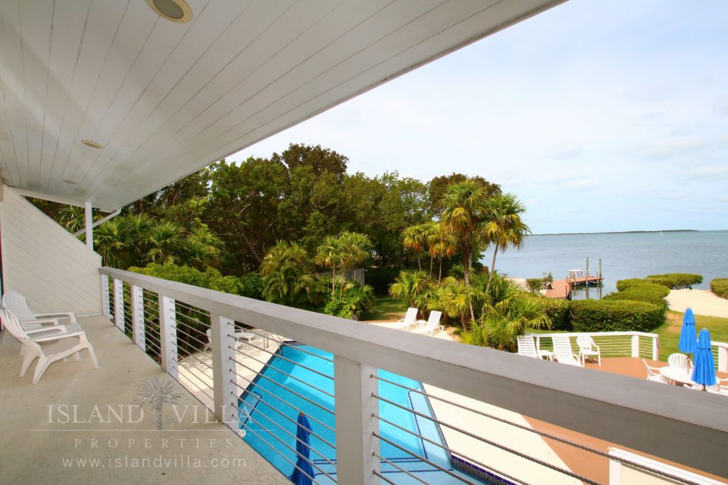 second floor master suite balcony overlooking the pool and florida bay