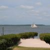 sail boat passing by the bay front property