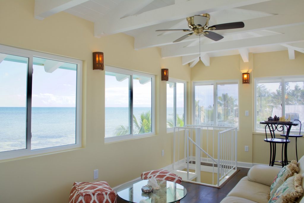 third floor sitting area with wall to wall windows overlooking the ocean